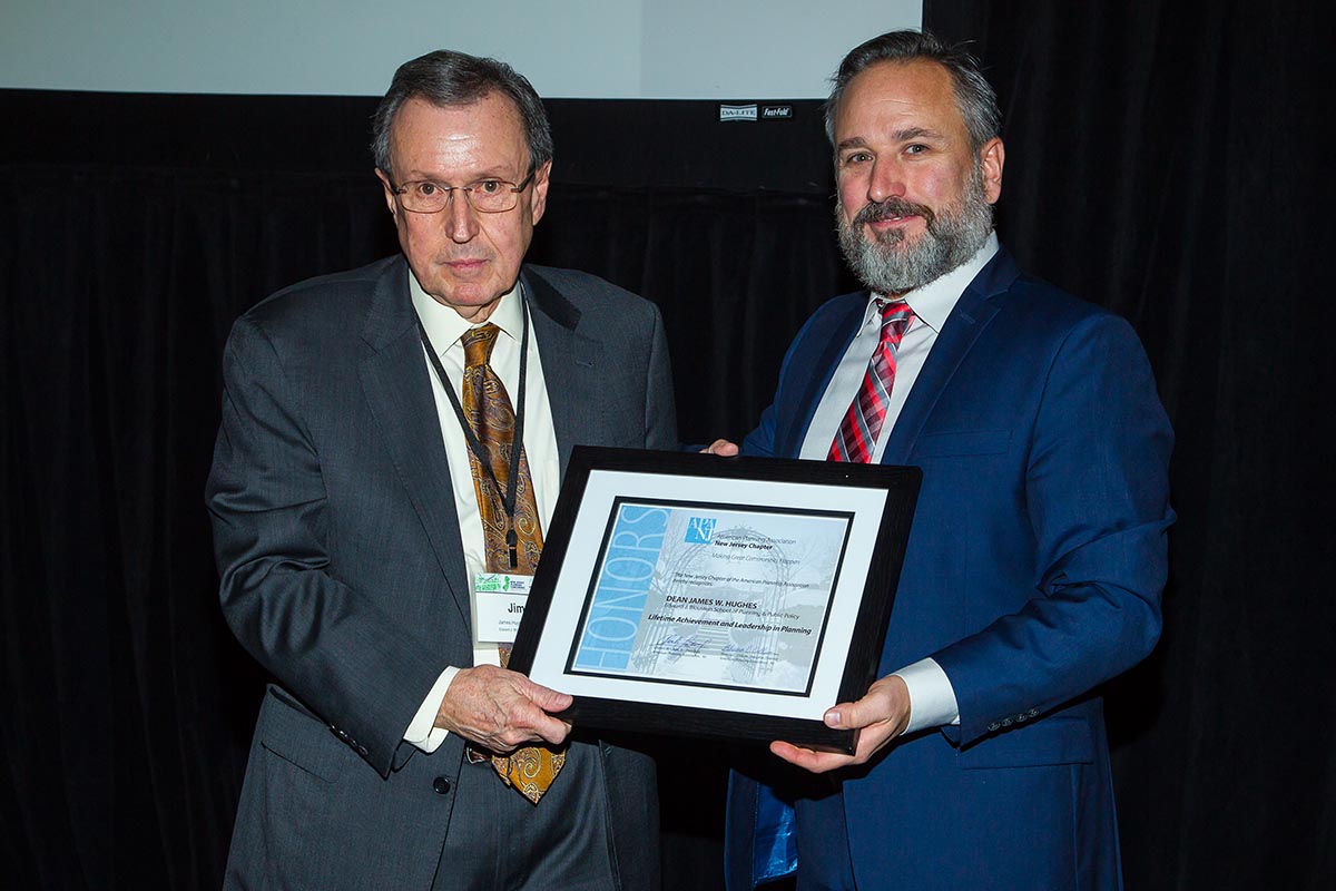 Charles Latini (right), President of the APA-NJ chapter, presents Dean James W. Hughes with the chapters Lifetime Achievement and Excellence in Planning award.