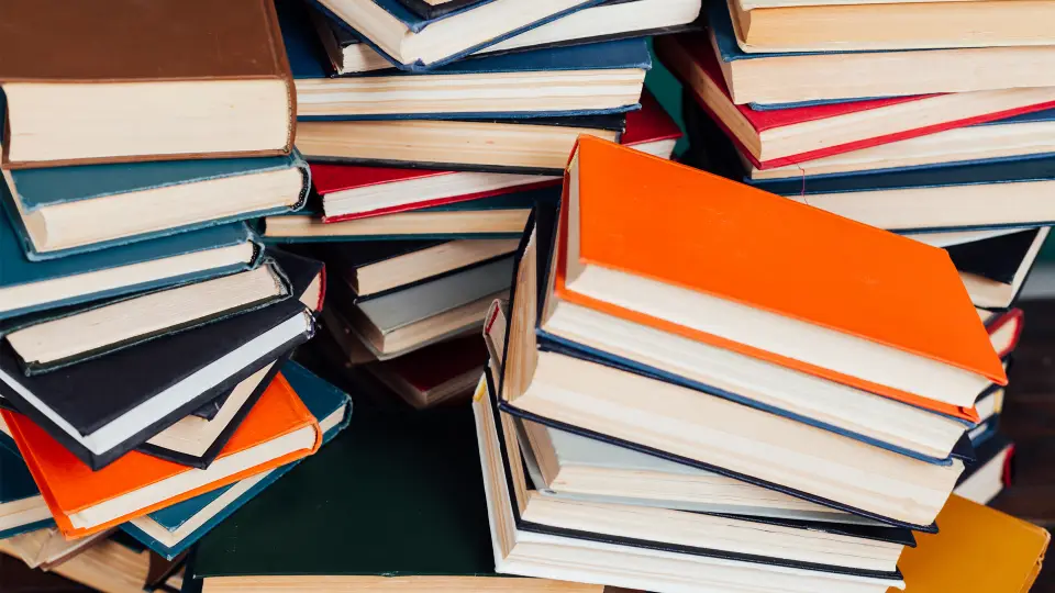Books on table. Library open office hours.