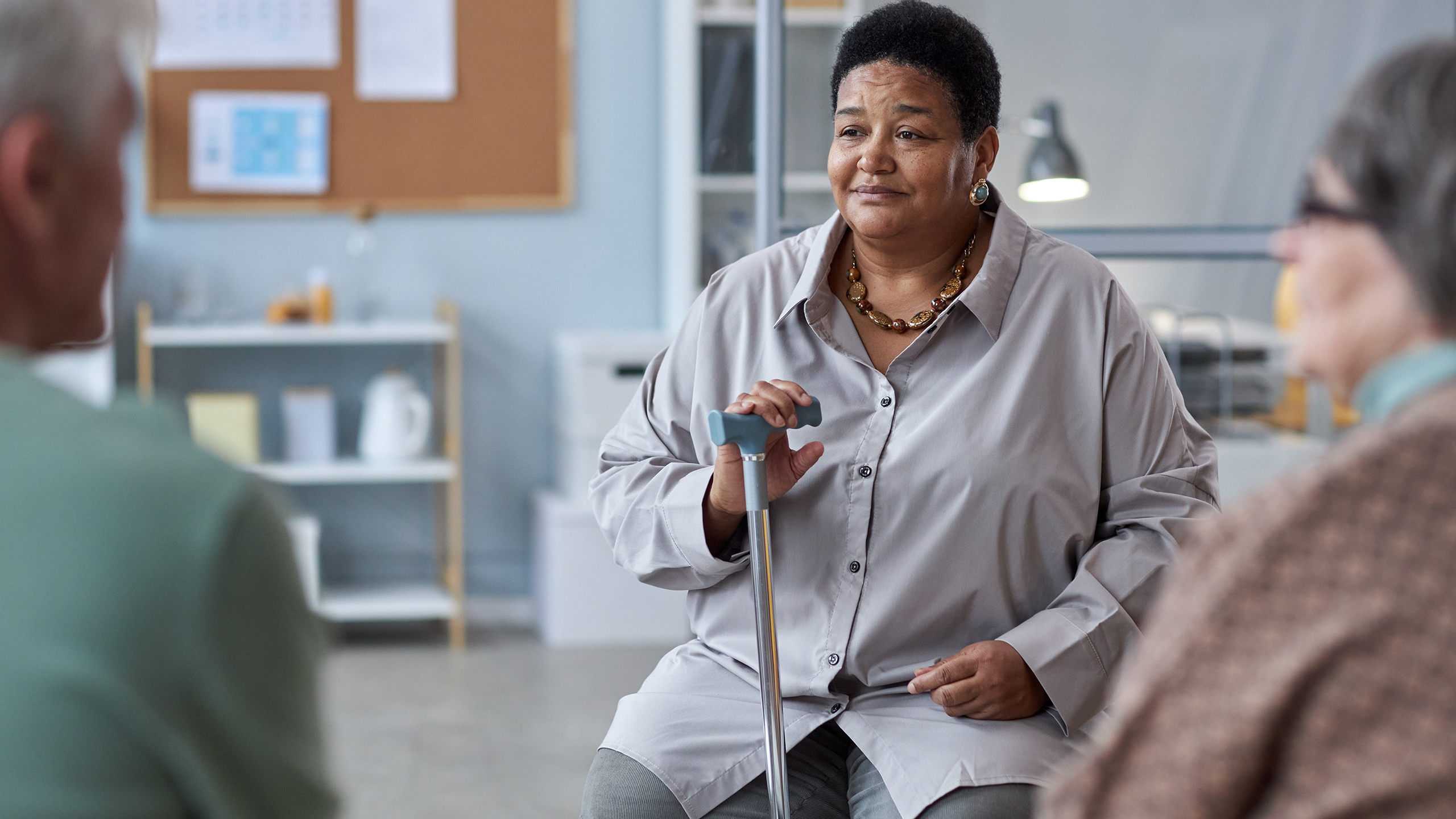 Senior black woman sitting in circle at mental health support group